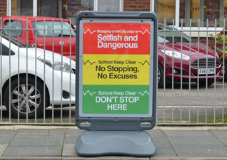 Advocate™ poster display sign with school parking and traffic calming notices