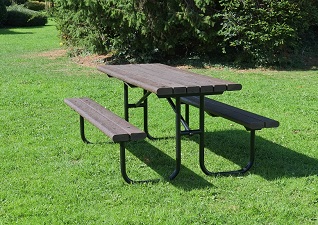 Bowland™ recycled material picnic table in brown with metal frame, situated on grassy area