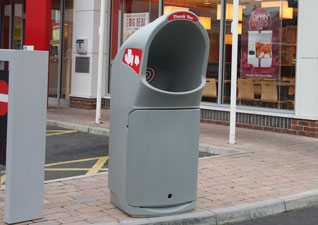 Combo Delta™ large capacity grey outdoor litter bin with large target opening outside fast food restaurant