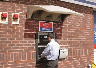 Eclipse™ Canopy Shelter in sandstone covering man using ATM cashpoint