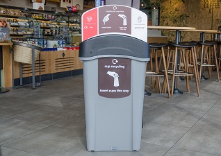 Eco Nexus® Cup Recycling Station in coffee shop with cup stackers and liquid reservoir
