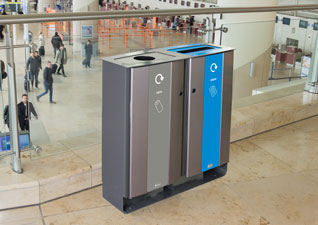 Electra™ Duo Recycling Bin in metal for cans and paper waste streams placed in busy train station