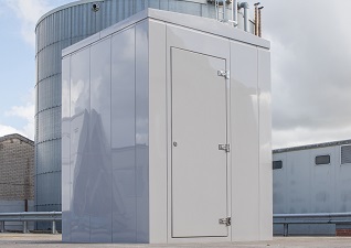 Element™ GRP Housing Enclosure in modern gloss finish in front of industrial building