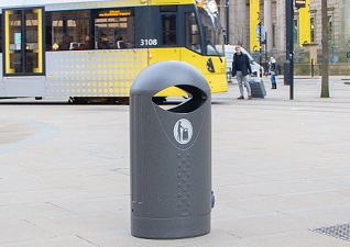 Elipsa™ Outdoor Street Litter Bin in millstone next to tram arriving into tram station
