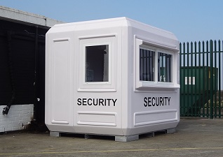 Genesis™ Security Booth Kiosk in white with security logo in front of green metal gate