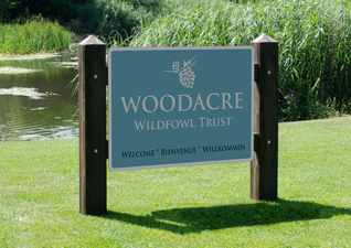 Glasdon Gateway signage site sign carrier in dark wood by lake