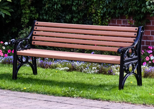 Lowther™ Traditional Outdoor Bench made from hardwearing material on hotel grounds