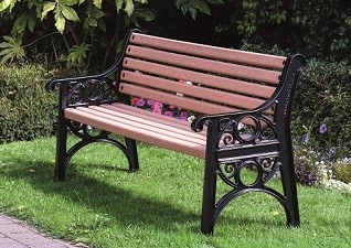 Lowther™ Park Bench Seat in recycled material wood effect on grassy area