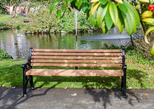 Lowther™ seat with wood effect slats by lake in park