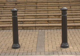 Manchester™ heritage bollards in black by school entrance way