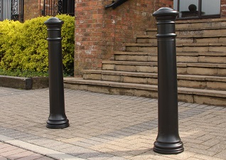 Manchester™ Bollards in black outside steps leading to building
