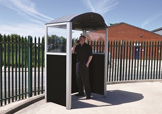  Modus™ multi-purpose waiting shelter being used by man on mobile phone
