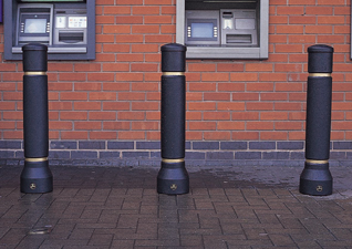 Neopolitan™ 20 Bollards in black with gold banding in front of ATM machines