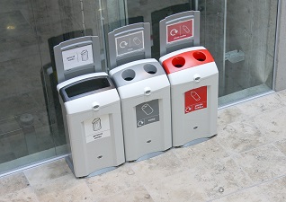 Nexus® 100 Indoor Recycling Bin for general waste, cans and plastic bottles with sign kits against glass door