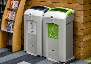 Nexus® 100 indoor recycling bins for general waste and mixed recyclables, situated in school library