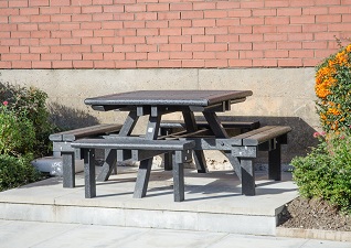 Pembridge™ Picnic Table in black recycled materials for 8 person seating on paving slab area