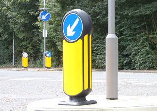 Rebound Signmaster™ Road Safety Bollard with luminous yellow body and keep left blue arrow signface on road island