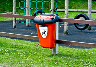 Retriever™ 35 dog waste bin in red on park