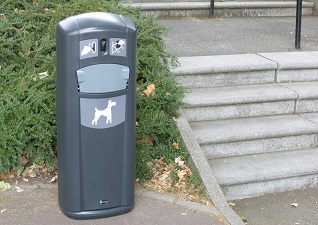 Retriever City™ Dog Waste Bin in Anthracite Grey with bag dispenser outside hotel entrance