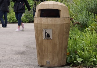 Sherwood™ light oak hooded outdoor litter bin on pathway in leisure centre