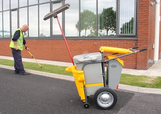 Single Space-Liner™ Orderly Barrow in grey with yellow lid and detailing with operator using litter grabber