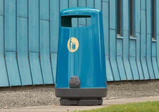 Topsy™ 2000 Outdoor Litter Bin in blue with litter graphic, sited outside large modern building on pathway