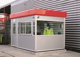 Warrior™ GRP Building in grey with red roof and man with high-visibility jacket inside operating