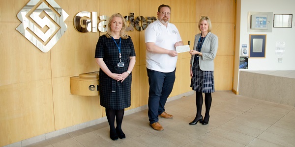 Members of Glasdon handing over donation to Counselling in the Community